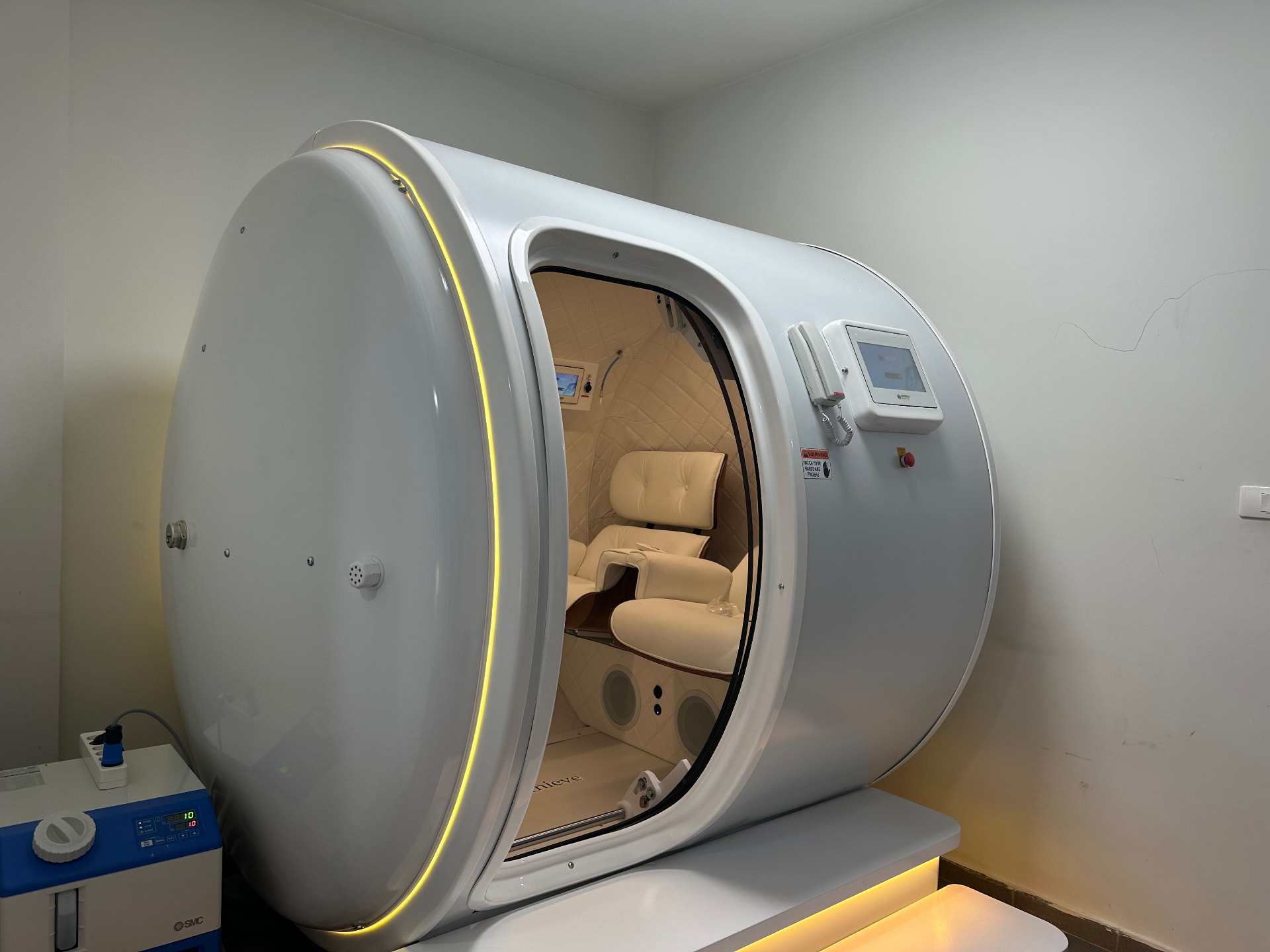 Exterior of the two-seat hyperbaric chamber at HBOT Clinic Lebanon, door open onto the treatment seats