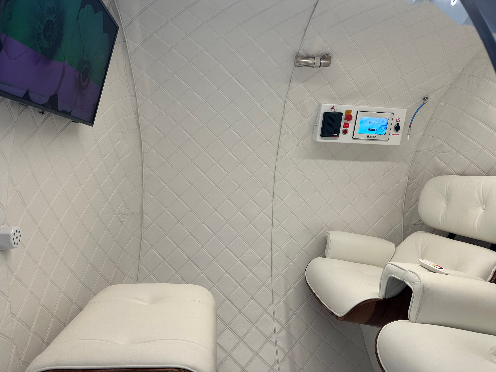 Comfortable reclining seats and viewing screen inside the hyperbaric chamber